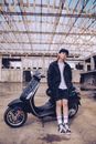 Man in Black Jacket and Blue Denim Jeans Sitting on Black Motorcycle