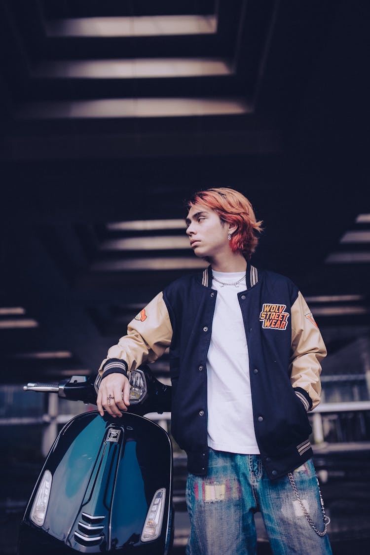 Man In Jacket Standing Beside Black Moped