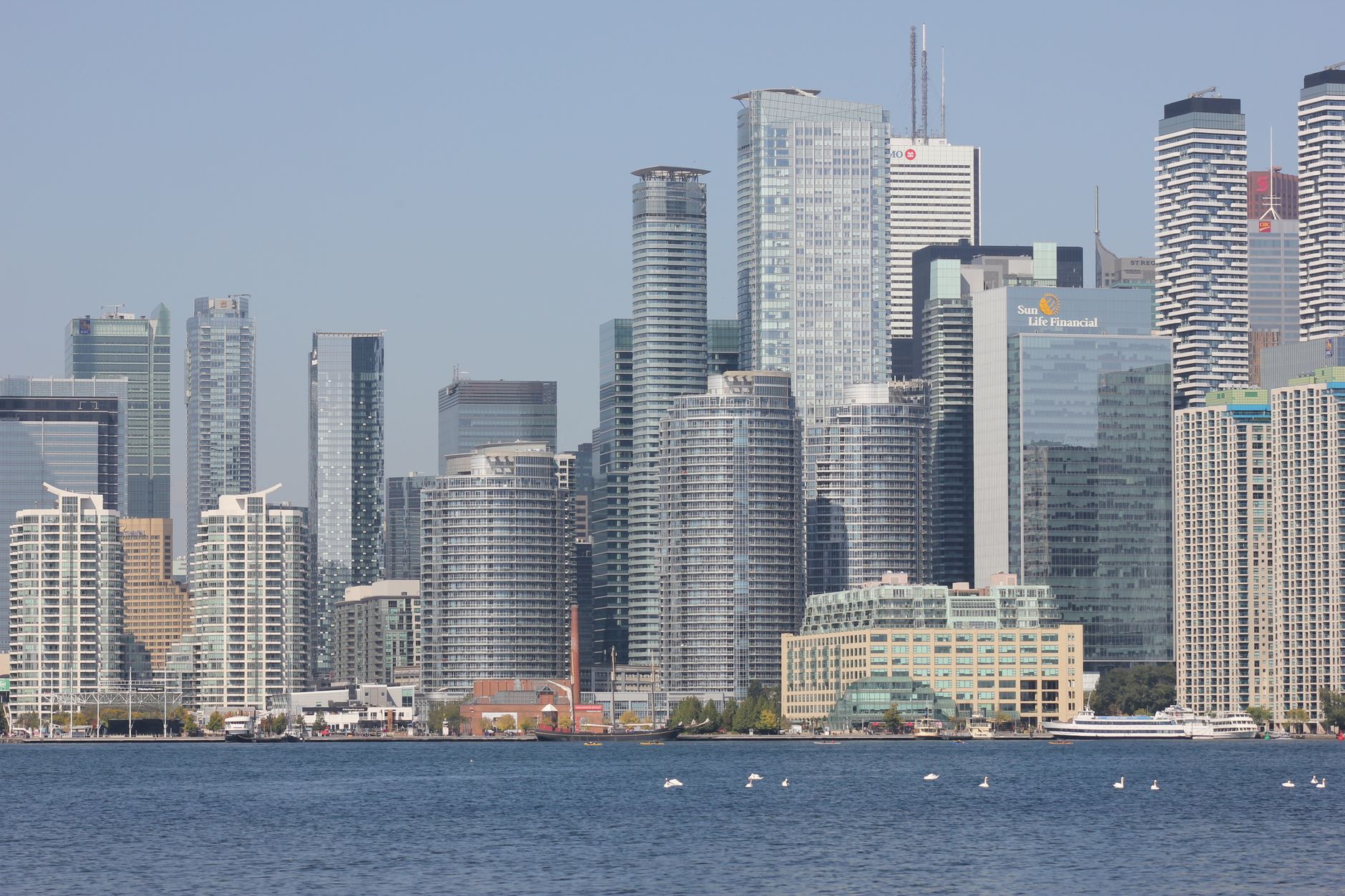 Panoramic view of Toronto skyline with modern skyscrapers and Lake Ontario.