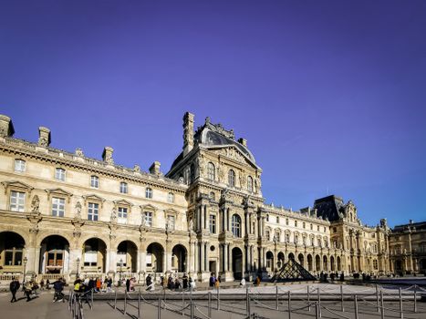 The magnificent facade of the Louvre Museum on a clear day in Paris, France.