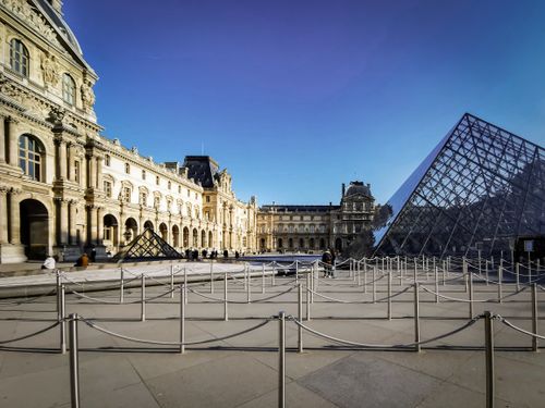 Free The iconic Louvre Museum with the glass pyramid entrance in Paris, France. Stock Photo