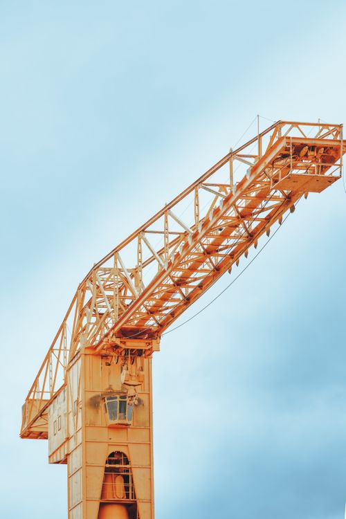 Free A tall construction crane set against a clear blue sky in Nantes, France. Stock Photo