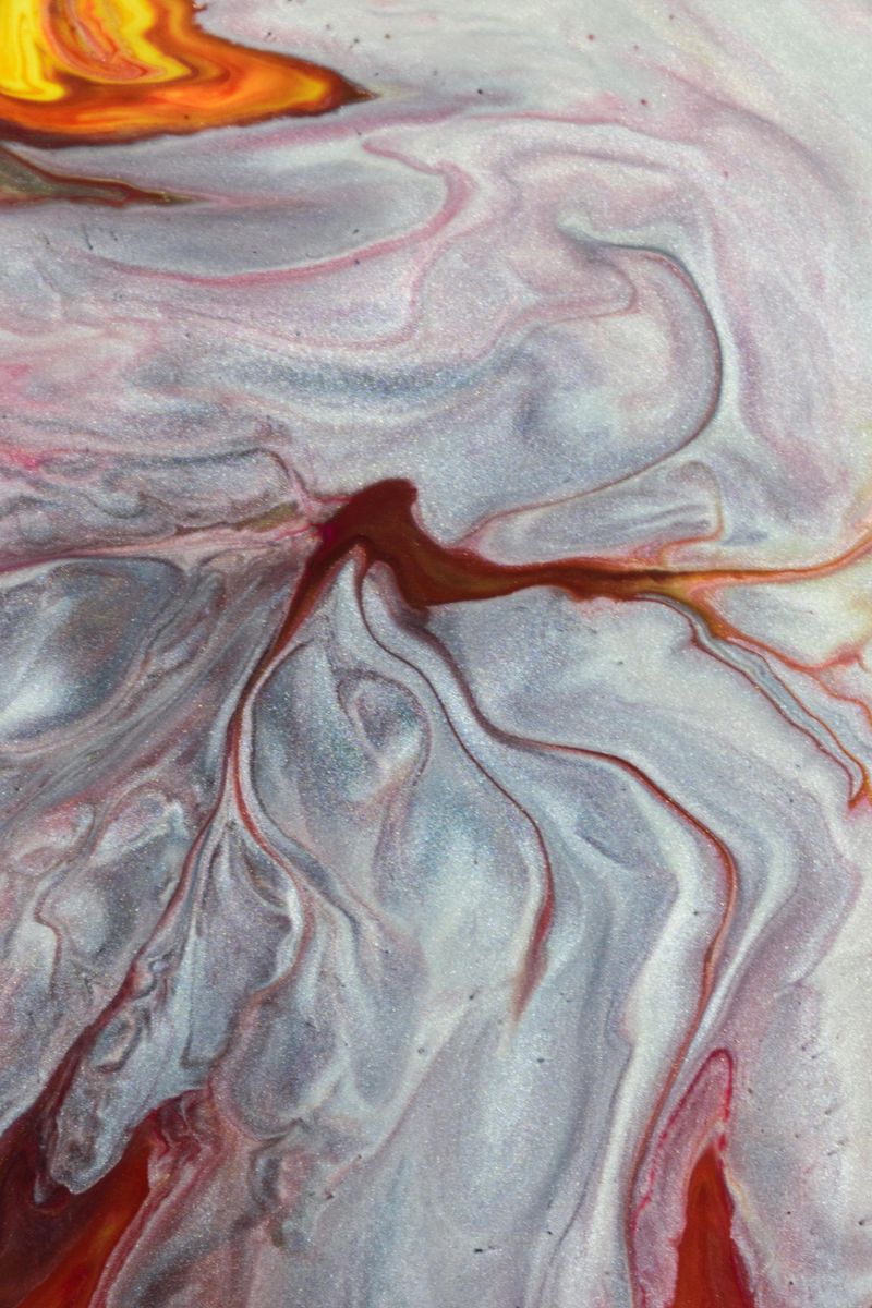 Dynamic abstract painting in fluid art style with vibrant swirls of color, creating an intense visual impact.
