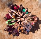 Group of People Lying on Brown Sand