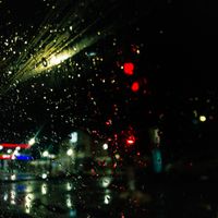 Playlist cover: city lights through a rainy windscreen — Serge Cyneat on Pexels