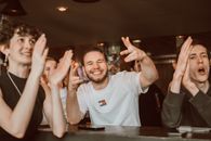 Man in White Crew Neck T-shirt Sitting at the Table