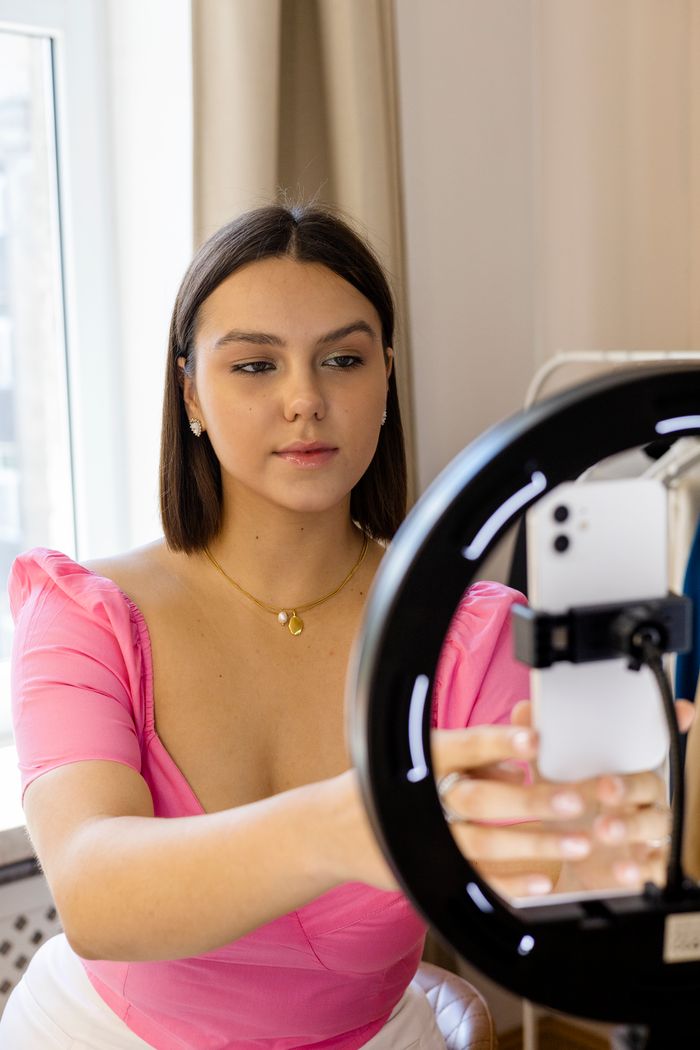 Creator recording content with a ring light