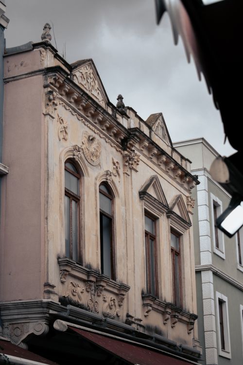 Free A beautifully detailed vintage building facade captured under a gloomy sky, showcasing historic architecture. Stock Photo