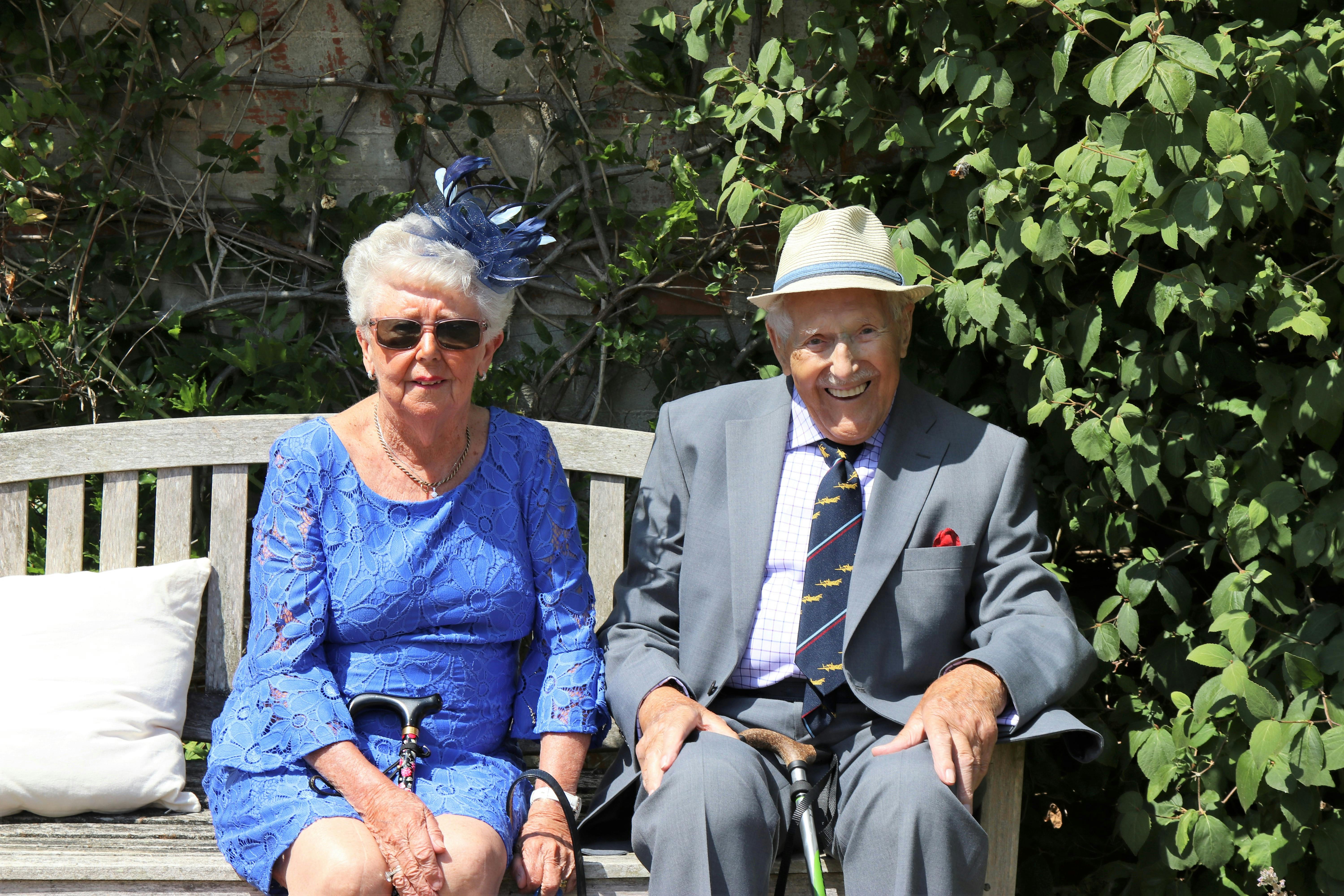 Image showing an elderly couple sitting on wooden bench. | Photo: Pexels