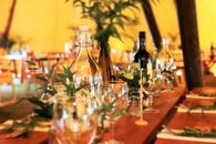 Wine Glasses and Wine Bottles on Top of Brown Wooden Table