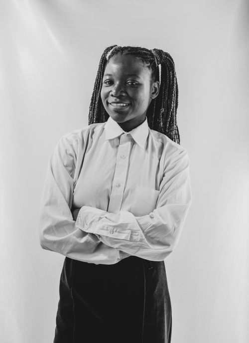 Free Striking black and white portrait of a woman with braided hair, exuding confidence and warmth. Stock Photo