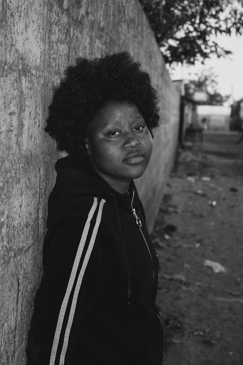 Fotobanka s bezplatnými fotkami na tému Afričanka, afro vlasy, betónový plot