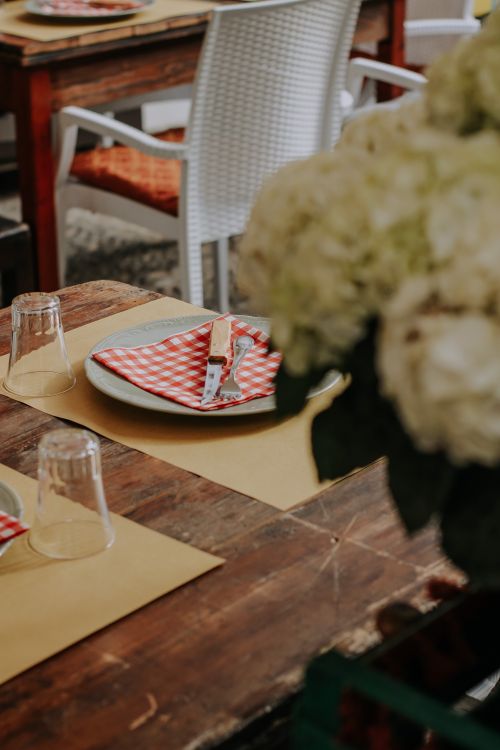 Free Rustic table setting with red checkered napkins and wooden decor. Stock Photo