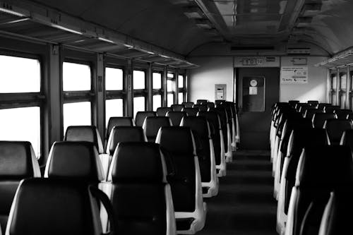 Black and White Photography of Empty Seats in the Train