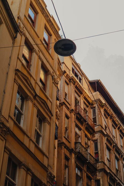 Free Discover the intricate architectural designs of city apartment facades from a dynamic low angle perspective. Stock Photo