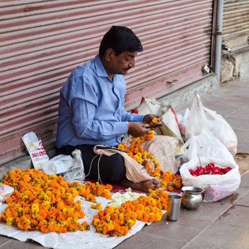 Man Selling Flower Chains on Street
