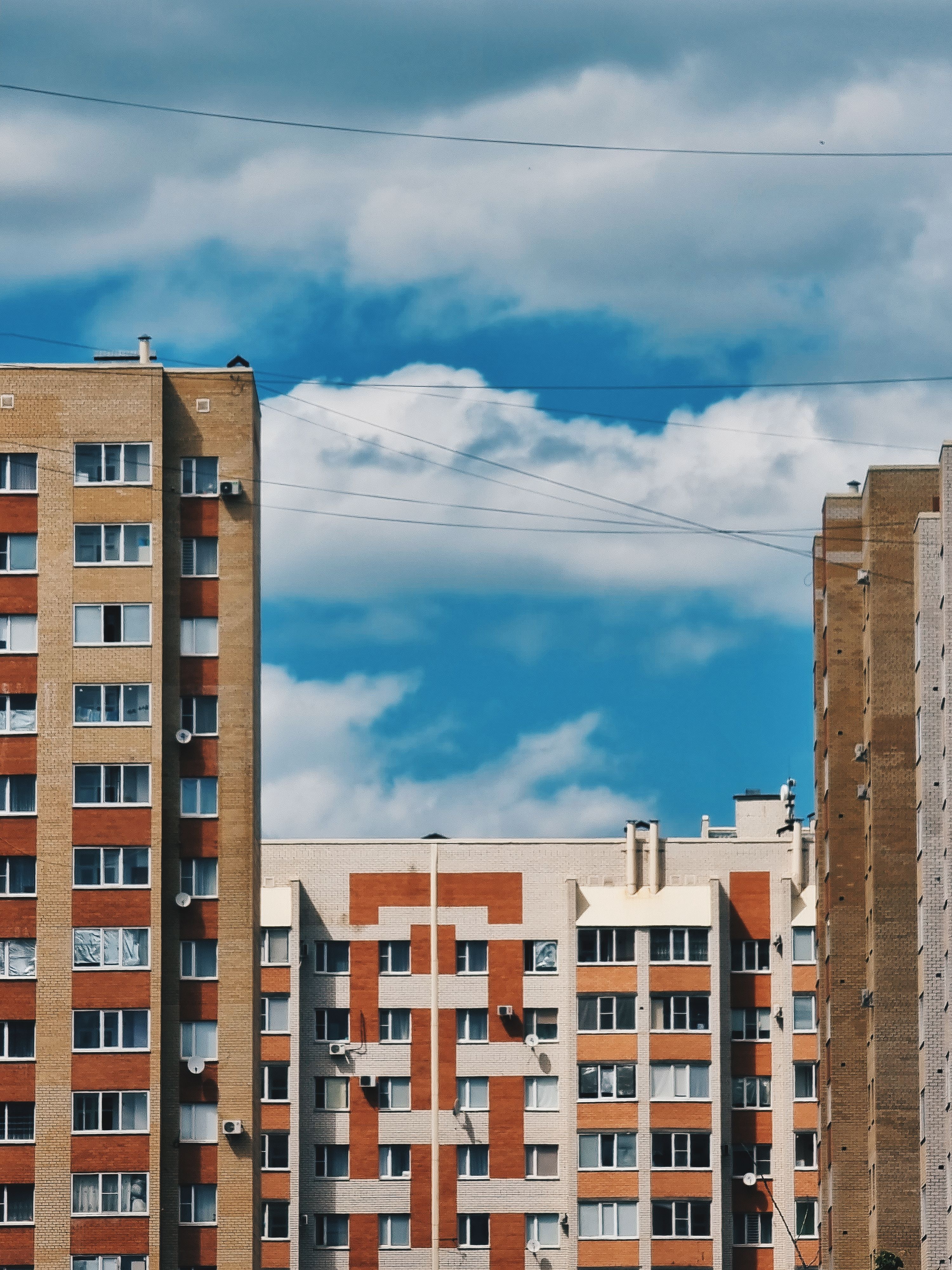 Brown and White Concrete Building Under Blue Sky and White Clouds ...