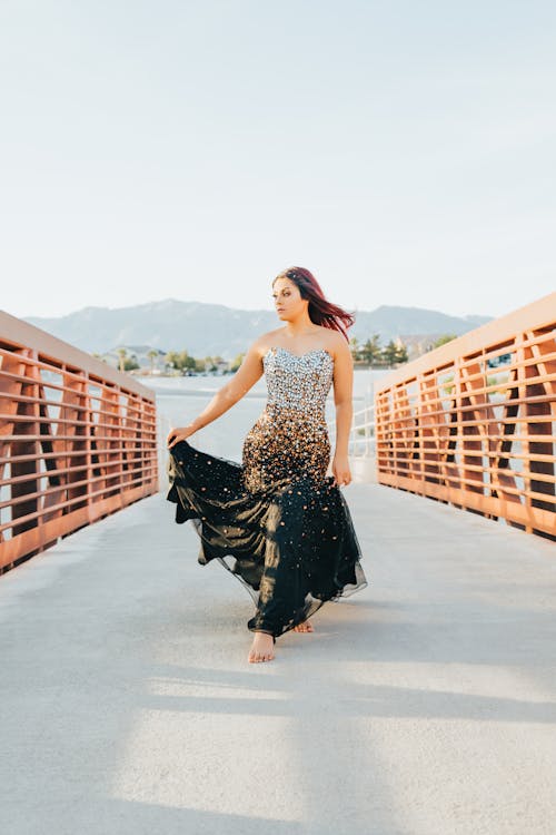 Long Dress Between Between Metal Fence