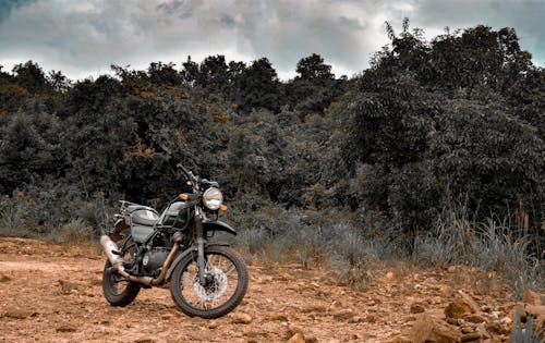 Motorcycle Parked on Dirt Road 