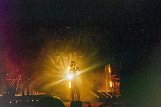 A dynamic live performance with stunning backlit lighting highlights the energetic ambiance.