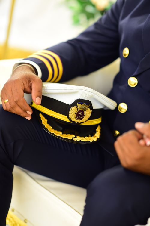 Free A close-up of a captain in uniform holding a hat, showcasing detailed attire. Stock Photo