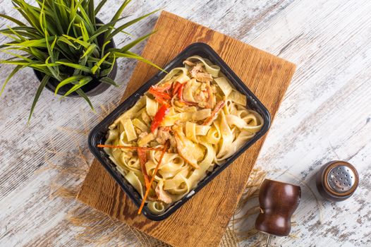 A mouthwatering dish of creamy fettuccine pasta with mixed vegetables, captured in a stylish overhead shot.