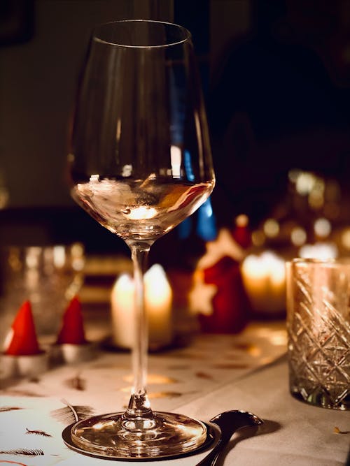 Clear Wine Glass on Brown Wooden Table
