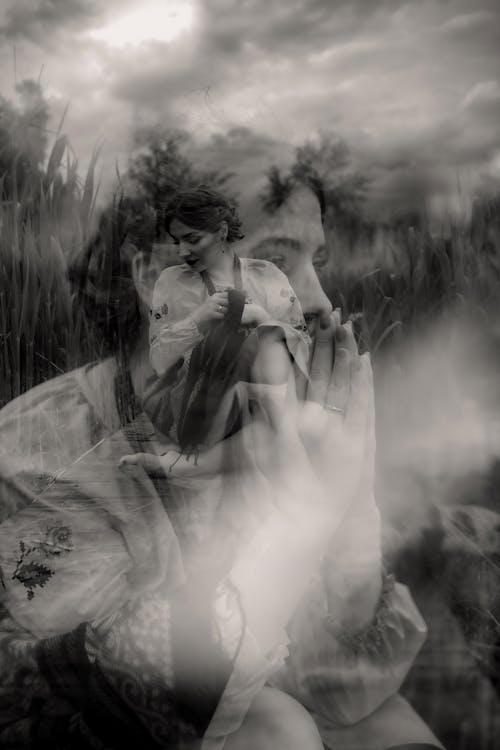 Double Exposure Photo of a Woman Sitting in a Field