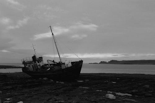 Black and White Photo of Shipwreck on the Shore