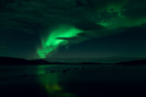 Free Stunning aurora borealis illuminating the night sky over Murmansk, Russia. Stock Photo