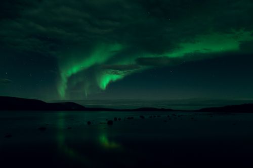 Free Capture of a vibrant aurora borealis lighting up the night sky in Murmansk Oblast, Russia. Stock Photo