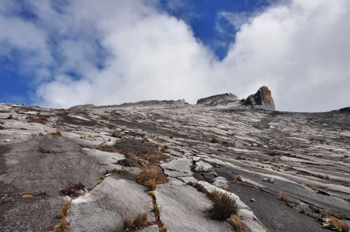 Free Stunning landscape of Mount Kinabalu's rocky summit under a clear blue sky in Malaysia. Stock Photo
