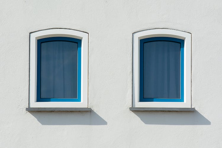 Blue Windows On House White Wall