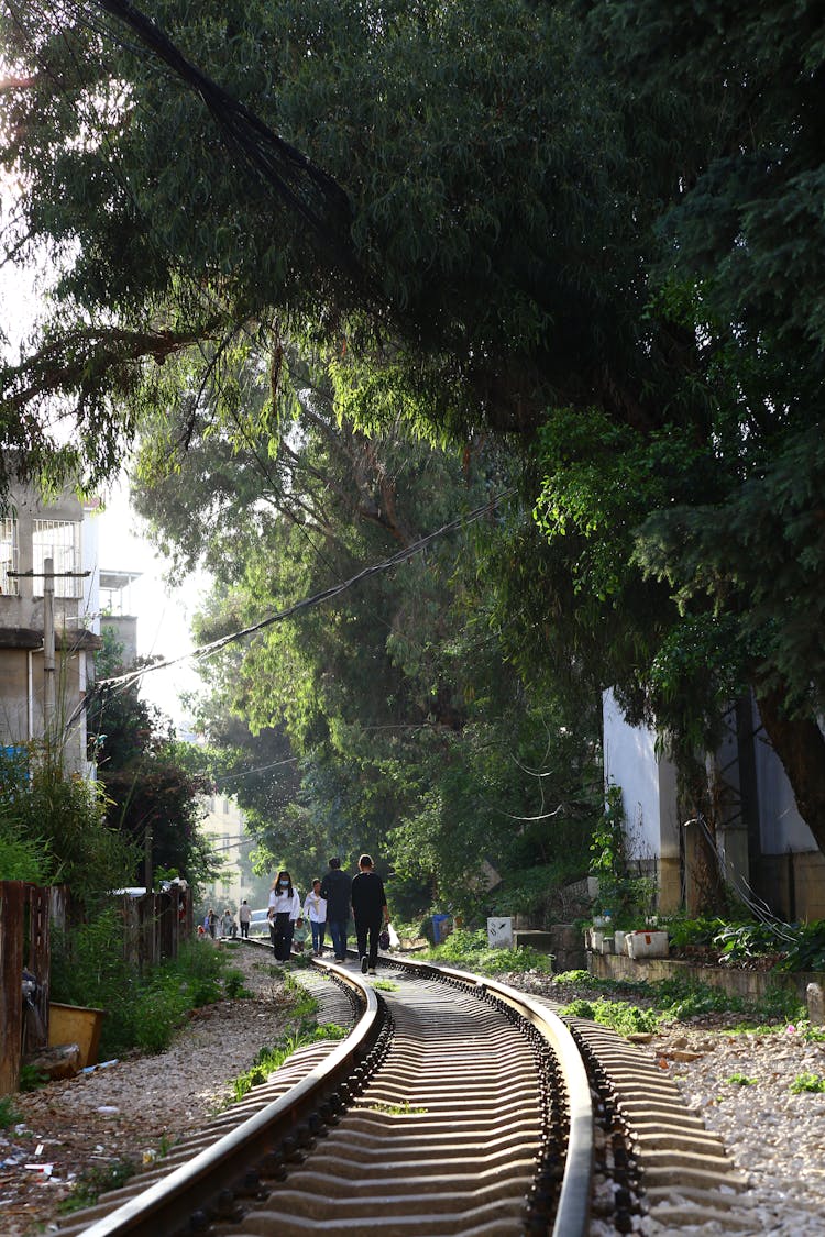 People Busy Walking On The Rail Track 