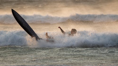 A Man Surfing on Ocean Waves