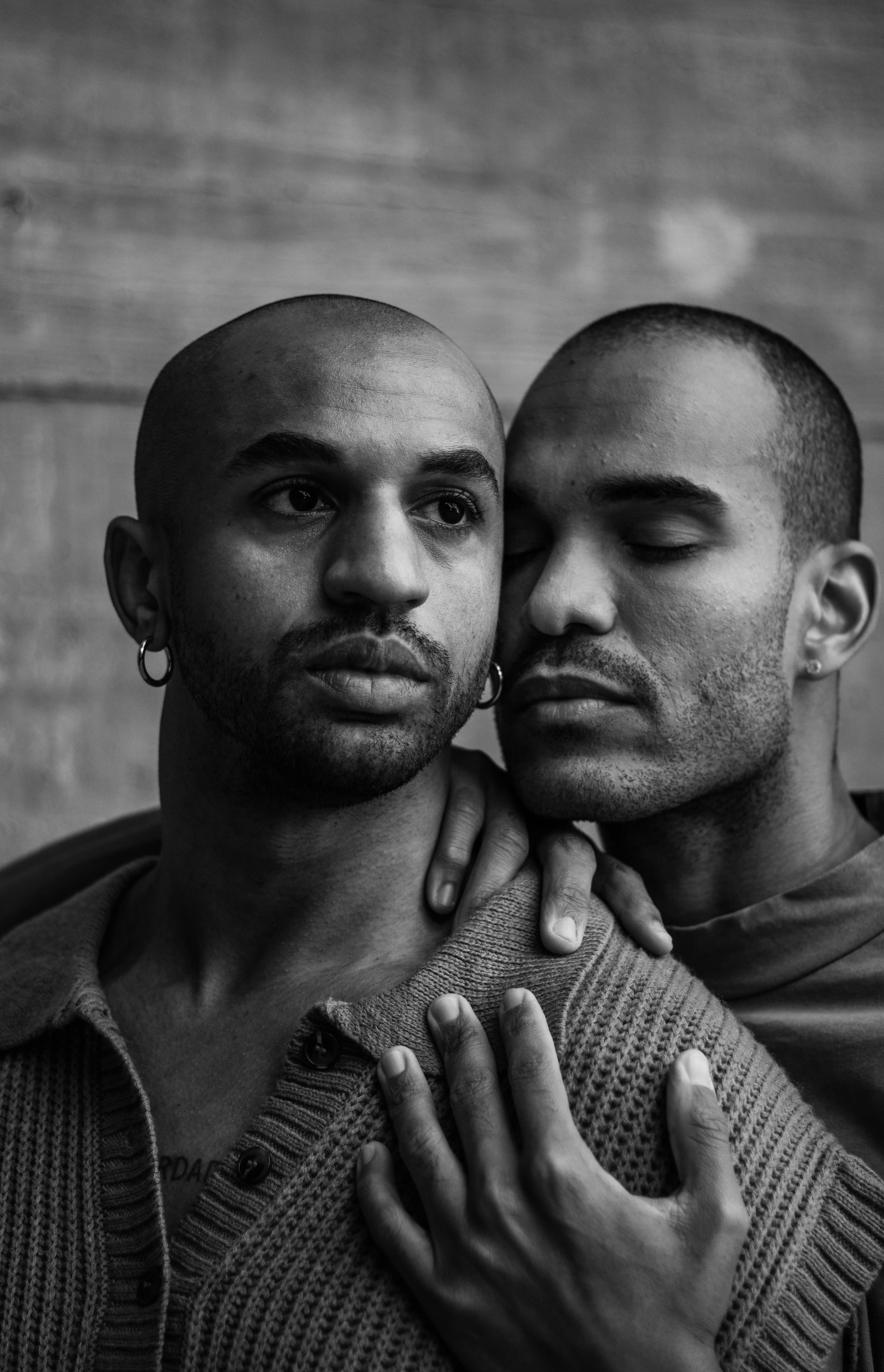 man holding his boyfriend with eyes closed