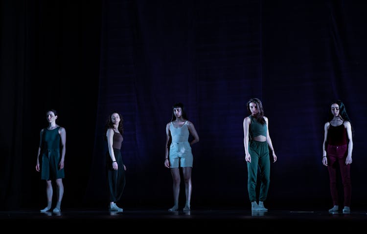 Women In Sportswear Posing On Black Stage