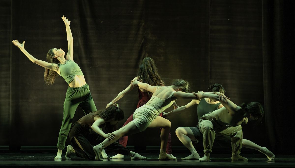 Contemporary ensemble performing on a dark stage