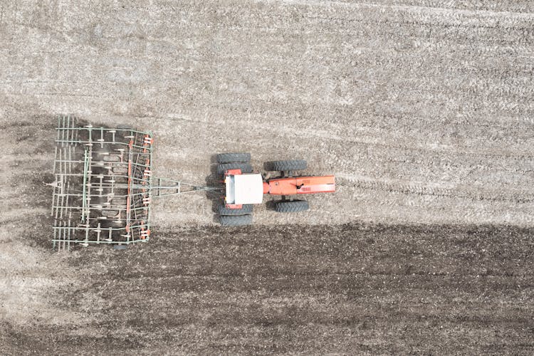 Top View Of Tractor Plowing Field