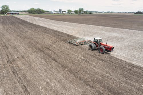 Red and Black Tractor on Brown  Field