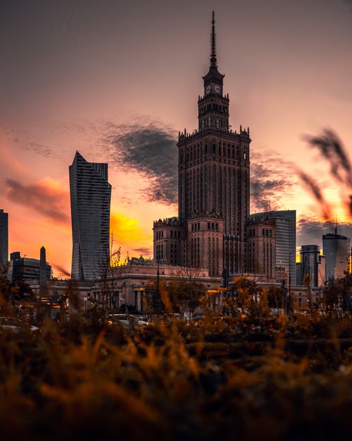 Free Stunning sunset view of Warsaw's Palace of Culture and Science and modern skyscrapers. Stock Photo