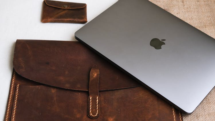 Laptop Computer On Brown Leather Bag