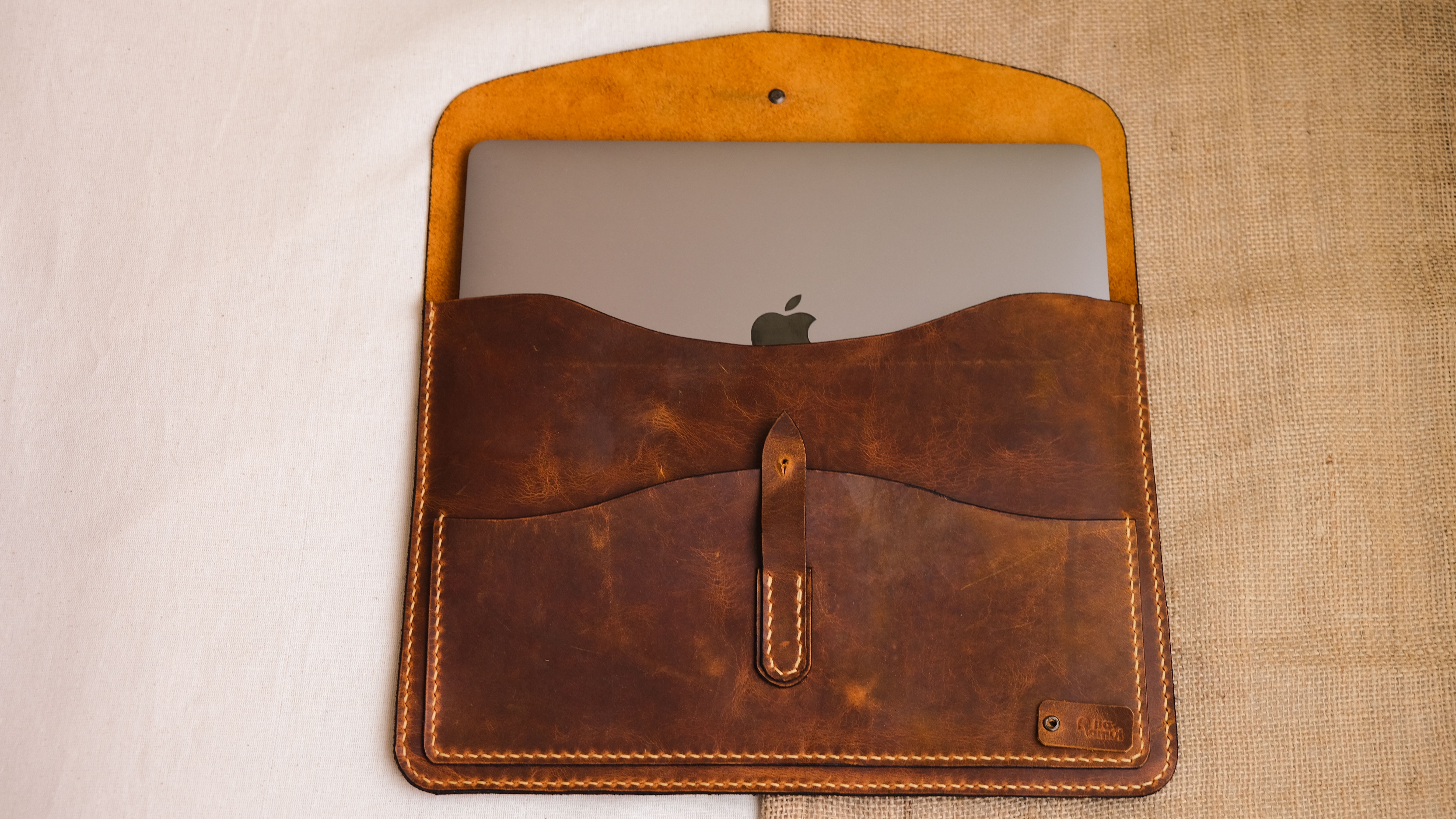 Close-Up Shot of a Laptop in a Leather Case
