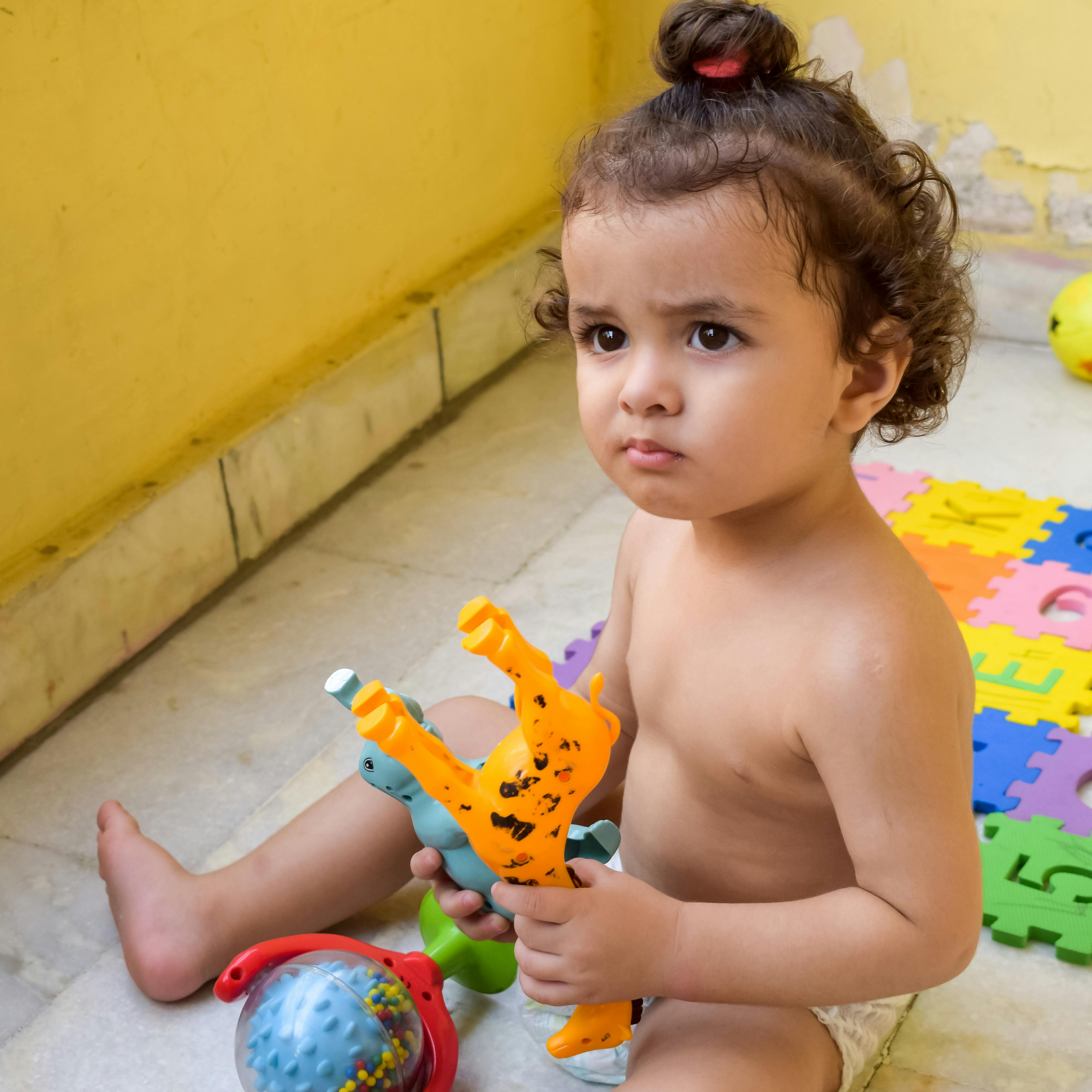 Topless Baby Playing with Plastic Toys · Free Stock Photo