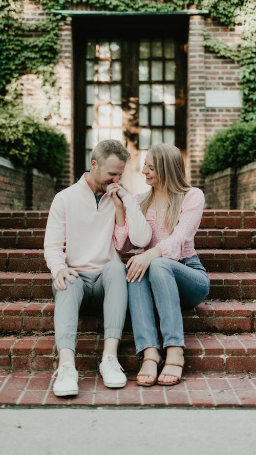 Woman and Man Sitting on Stairs