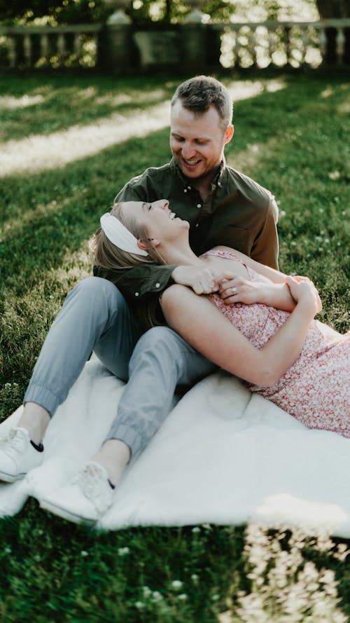 Couple Smiling on Blanket on Grass