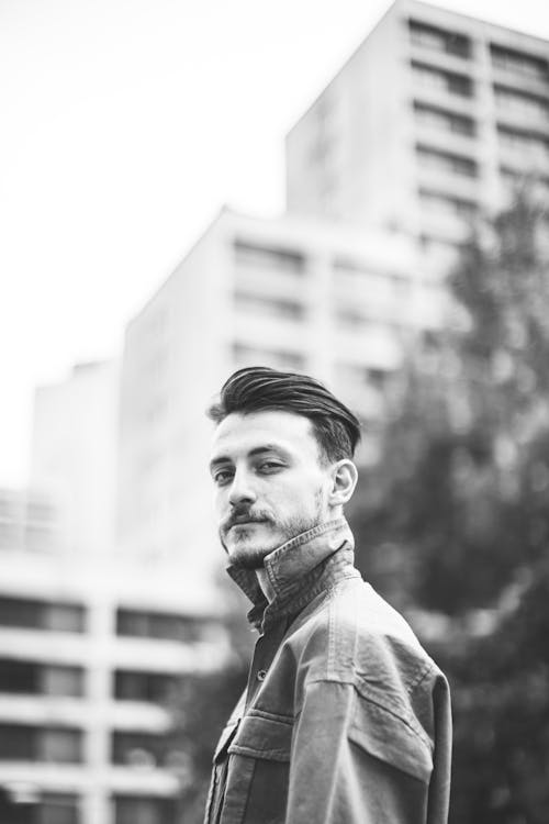 Black and White Photo of a Man Wearing Jacket