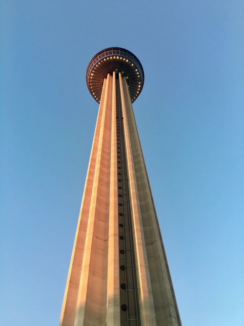 Free The iconic Tower of the Americas in San Antonio, Texas, showcased against a clear blue sky from a low angle. Stock Photo