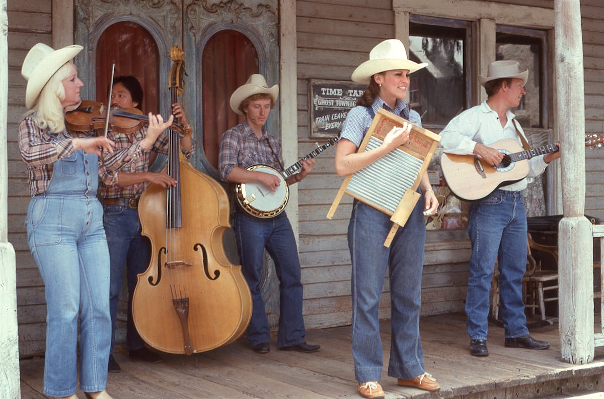 People in Cowboy Hats Playing on Musical Instruments 