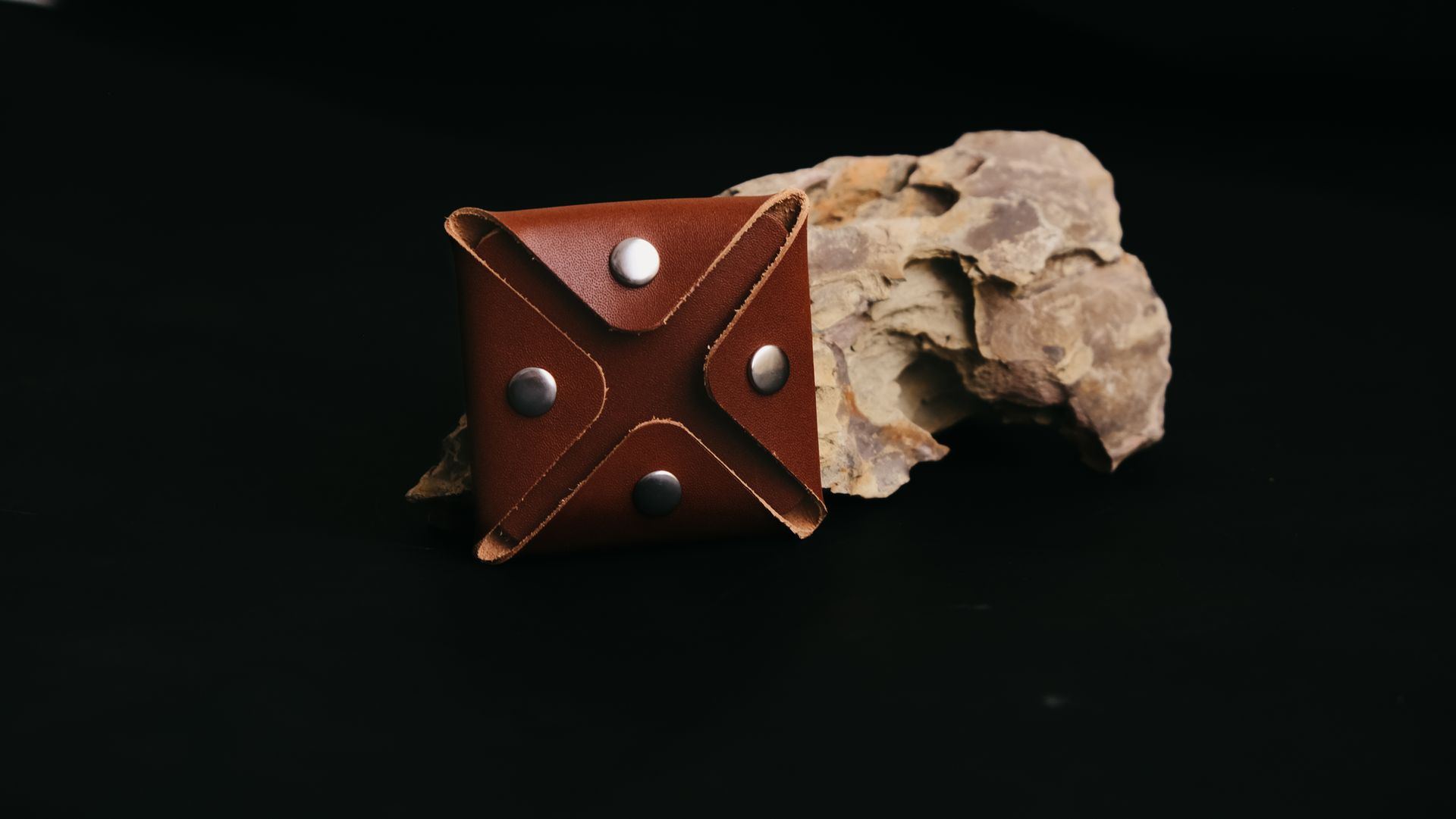 Elegant handcrafted leather case with metal rivets, perfect for stylish storage and carrying.